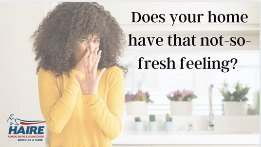 woman holding nose because of foul odor