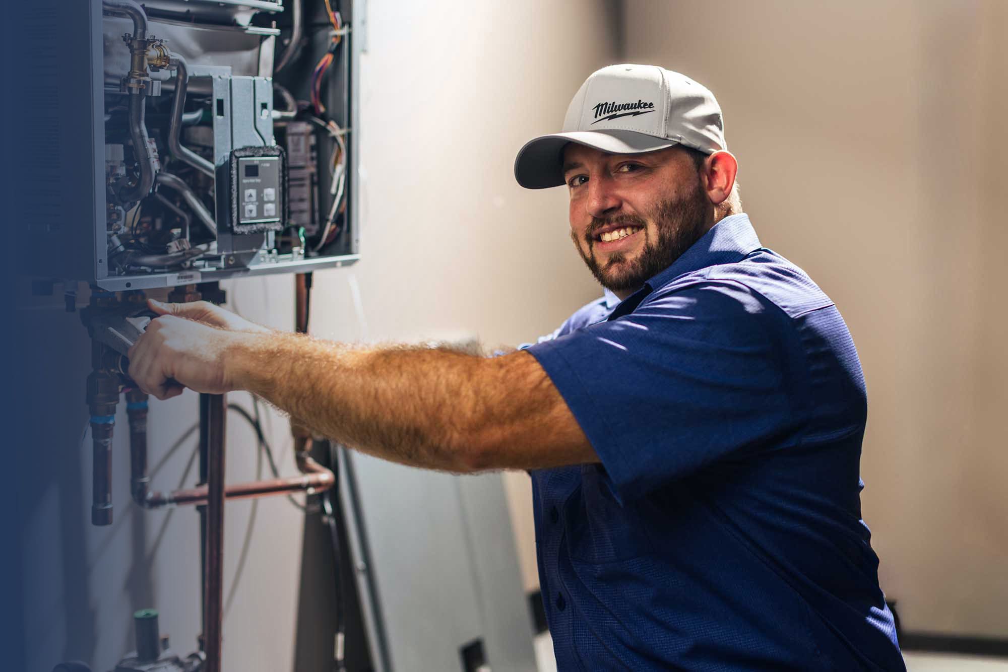 Tech working on a tankless water heater